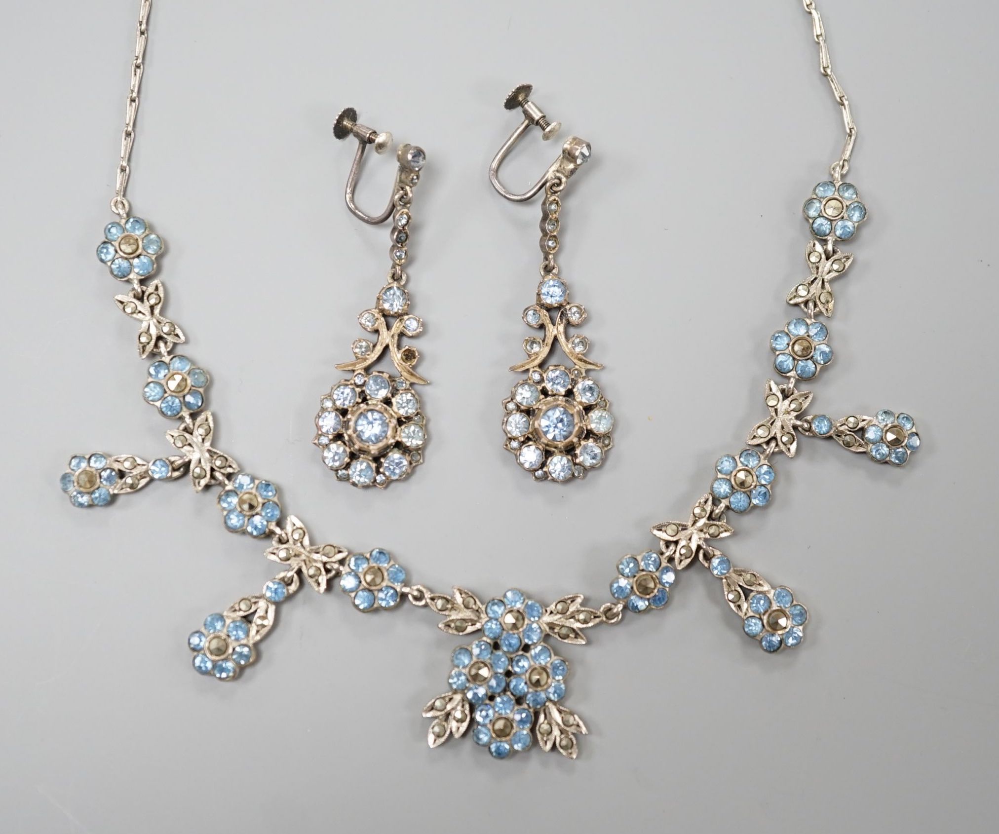 A base metal, marcasite and blue paste set necklace and pair of matching drop earrings, necklace 41cm, earrings 42mm.